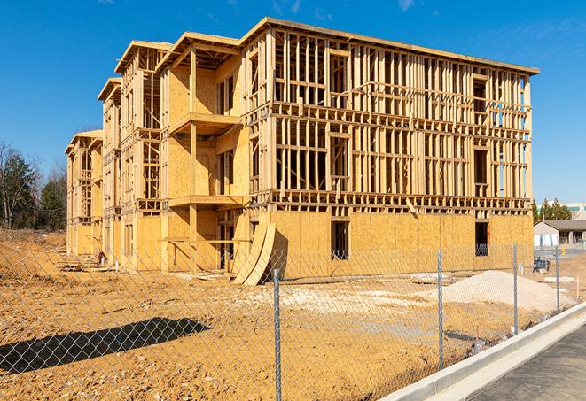 a temporary chain link fence in front of a building under construction, ensuring public safety in Hamlin TX